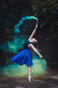 woman-standing-by-one-foot-and-holding-flare-stick-near-1886694 (1)