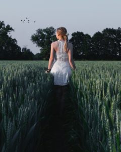 woman-in-white-sleeveless-dress-near-green-plants-1188745
