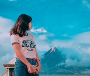 photography-of-a-girl-in-front-of-erupting-volcano-823397