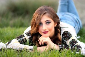 woman-lying-on-green-grass-field-during-daytime-89779