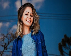 woman-wearing-blue-shirt-and-denim-jacket-1130624